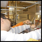 Photo of Test, Adjust and Balance Technician doing work